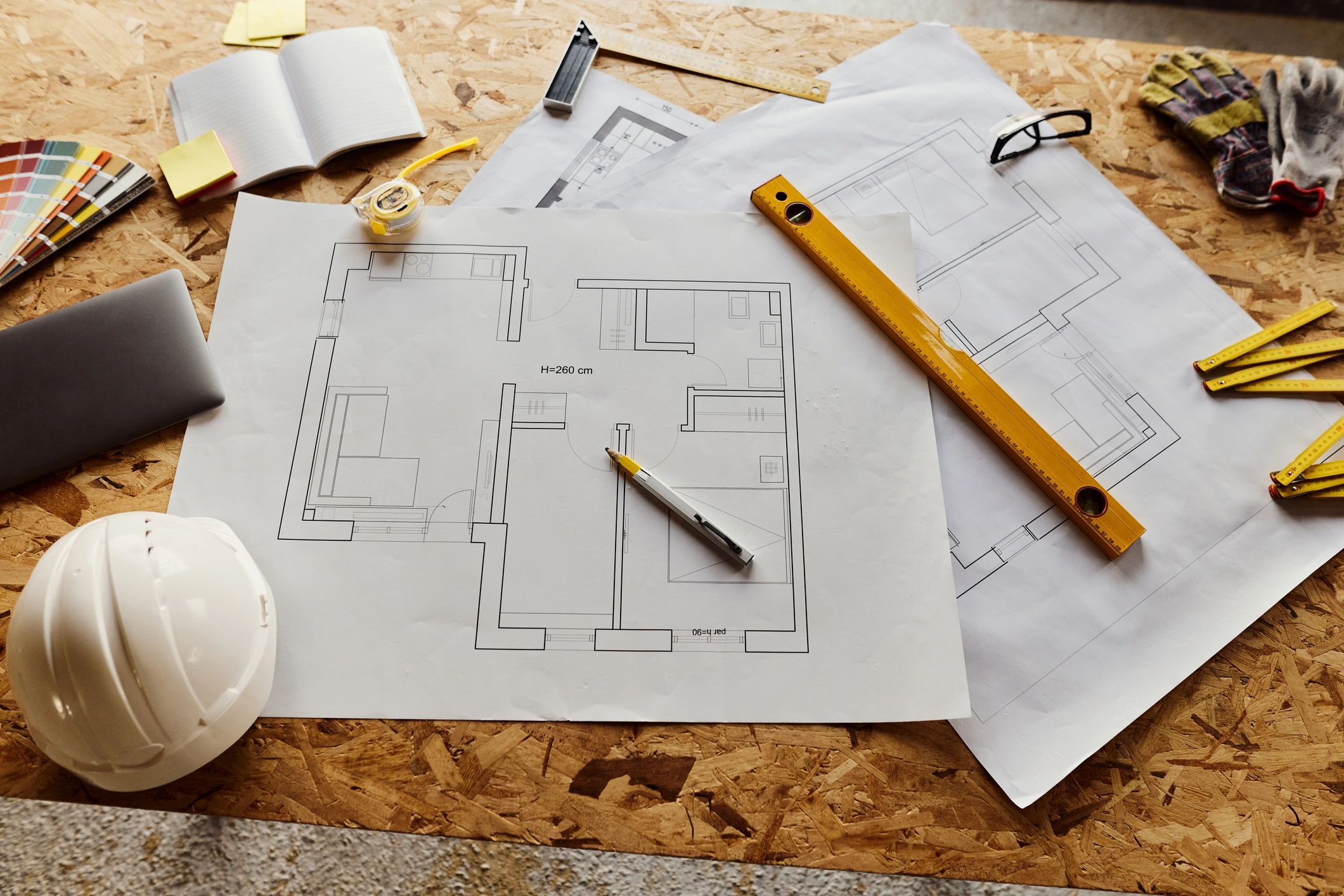 Construction drawings and tools on a desk