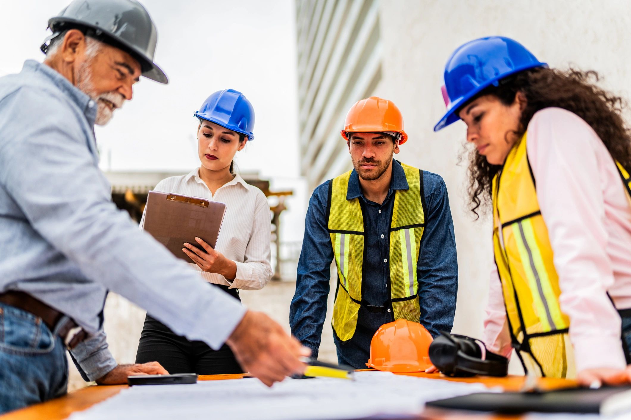 Construction project team reviewing plans on site
