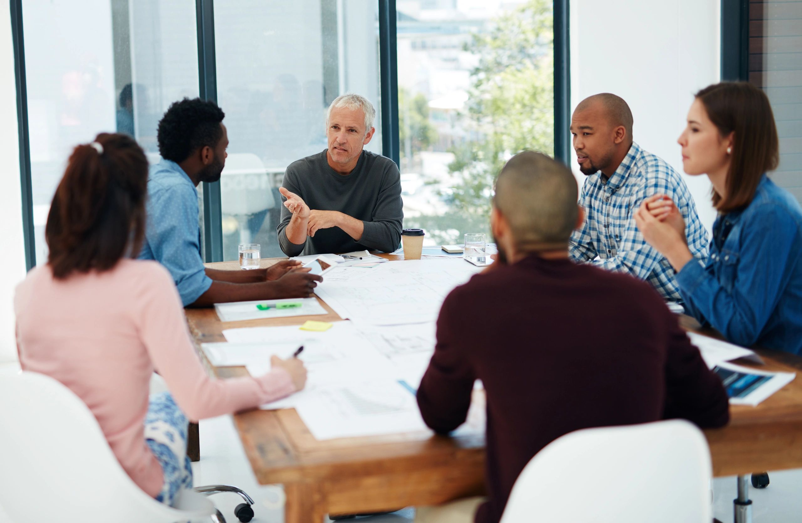Project team working through plans in a boardroom